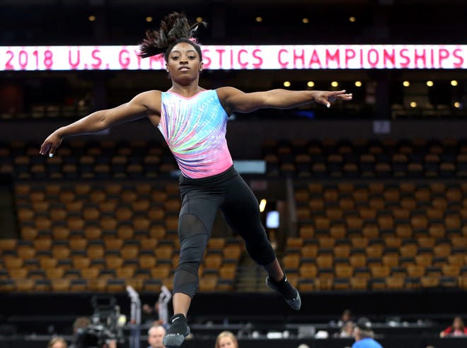 Simone Biles practices on the floor during a training session at the U.S. Gymnastics Championships, Wednesday, Aug. 15, 2018, in Boston. (AP Photo/Elise Amendola)