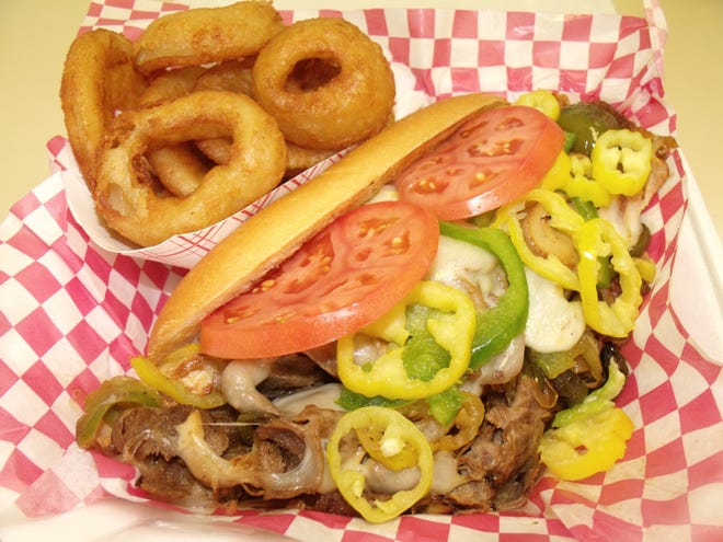 The Deep Creek cheese steak includes fries and a drink. Onion rings may be substituted for an additional charge. The sandwich comes with grilled chicken and steak, grilled onions, peppers, mushrooms banana peppers and melted provolone cheese. [Alison Minard for The Fayetteville Observer]