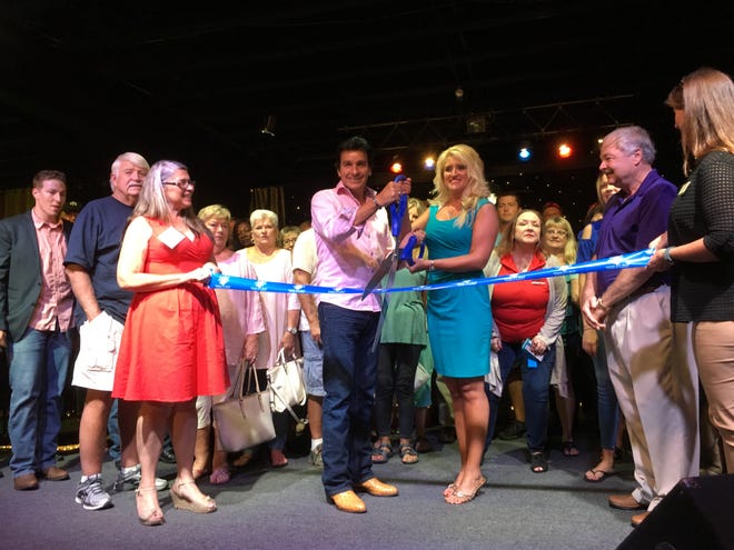 Todd and Angel Herendeen cut the ribbon at the official event on Wednesday, Aug. 15, 2018. [PHOTOS BY TONY SIMMONS/THE NEWS HERALD]