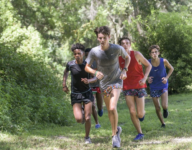 Members of the defending state Class 1A state champion Mount Dora Christian Academy cross country team run the course at the school on Wednesday. [PAUL RYAN / CORRESPONDENT]