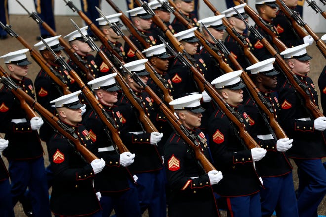 FILE - In this Jan. 20, 2017 file photo, Marines march during the 58th Presidential Inauguration parade for President Donald Trump in Washington. Trump’s lofty vision of big tanks and vintage aircraft moving through the streets of Washington in a show of patriotic force crumbled Friday under the weight of logistics, including a $92 million price tag. (AP Photo/Pablo Martinez Monsivais)