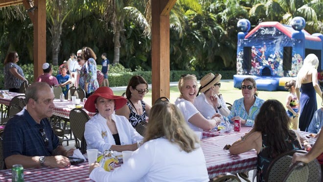 Approximately 100 people attended the Temple Emanu-El open house and welcome-back barbecue in the temple’s Abraham Garden in 2016. (Melanie Bell/Daily News)