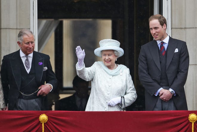 In this June 5, 2012, file photo, Queen Elizabeth II, center, accompanied by Prince Charles, left, and Prince William, appear on the balcony of Buckingham Palace in central London, to conclude the four-day Diamond Jubilee celebrations to mark the 60th anniversary of the Queen's accession to the throne. The Associated Press has found that stories circulating on the internet that Queen Elizabeth II will pass the crown directly to her grandson Prince William, are untrue. [LEFTERIS PITARAKIS/THE ASSOCIATED PRESS]