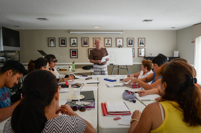 In this 2016 photo, Jack Bothelo, a volunteer for the Literacy Council of Sarasota, holds a "conversation class" for adults learning how to read and write in English. [Herald-Tribune Archive]