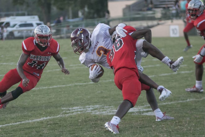 New Hampstead's Jeremiah Daniels is taken down by Jenkins High's Edward Osborne during the Friday Night Blitz Game of the Week on Aug. 18, 2017 at Memorial Stadium. The same match-up will be the 2018 season opener on ESPN Coastal's radio broadcast schedule. [RANDY THOMPSON/SAVANNAH MORNING NEWS FILE PHOTO]