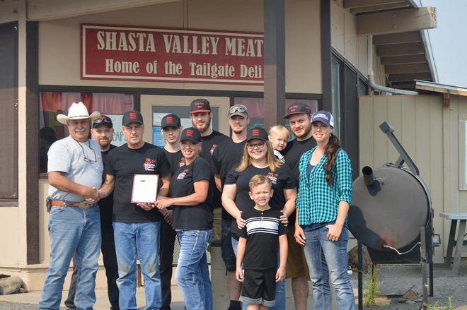 Siskiyou County Cattlemen President Greg Kuck and University of California Cooperative Extension Livestock and Natural Resources Advisor Carissa Rivers presented the Cattlemen's Ally of the Industry award to Doug and Holly Hamblin, owners of Shasta Valley Meats. Also 
pictured are Shasta Valley Meats employees Reanne Back, Brandon Back, Bryan Back, Ben Back, Brandon Keele, Mike Baham and the Hamblin's grandchildren – Koltyn Back and Camden Back. Lexi Hamblin, not 
pictured, is also part of the Shasta Valley Meats team.