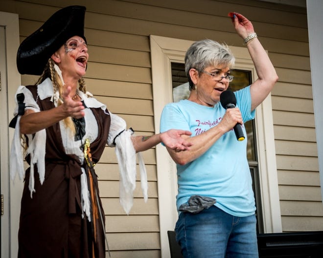 Pirate Rachel Leopold and Pat Dumon, Fairfield Harbour Neighborhood Watch Chair, pull out winning raffle tickets at the National Night Out event. [Submitted photo]