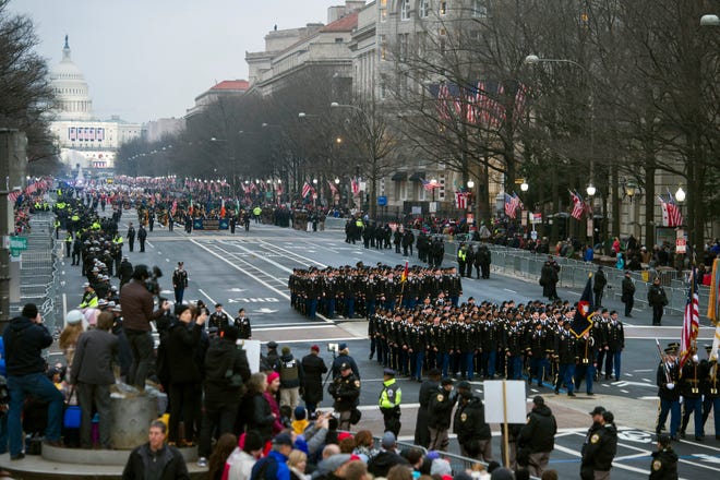 FILE - In this Jan. 20, 2017, file photo, military units participate in the inaugural parade from the Capitol to the White House in Washington, Friday, Jan. 20, 2017. A U.S. official says the 2018 Veterans Day military parade ordered up by President Donald Trump would cost about $92 million _ more than three times the maximum initial estimate. (AP Photo/Cliff Owen, File)