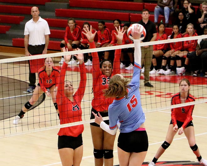 Southside's Avery Fitzgerald looks to hit over the Northside defense of Rebekah Krehbiel and Nakiah Wills on Thursday, Aug 16, 2018, during the second set at Kaundart-Grizzly Fieldhouse. [JAMIE MITCHELL/TIMES RECORD]