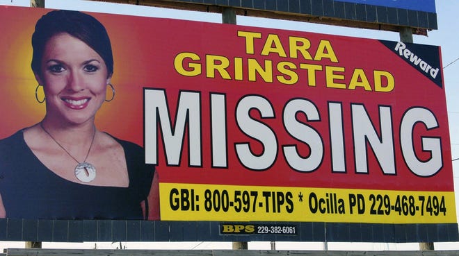 South Georgia teacher Tara Grinstead's image is displayed on a billboard in Ocilla, Ga., on Oct. 4, 2006. New court documents suggest that within weeks of her disappearance, two of her ex-students told friends at a party they had killed her and burned her body. [AP Photo/Elliott Minor, File]