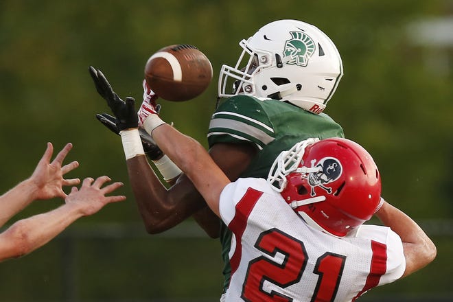 Athens Academy's Deion Colzie brings in a pass for a touchdown while being defended by Savannah Christian's Blake Brown during a GHSA high school football game between Athens Academy and Savannah Christian Friday night. (Photo/Joshua L. Jones, Athens Banner-Herald)