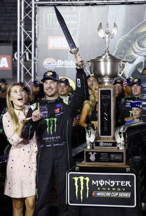 Kurt Busch celebrates with his wife, Ashley Van Metre, after winning the NASCAR Cup Series auto race Saturday in Bristol, Tenn. [Wade Payne/The Associated Press]