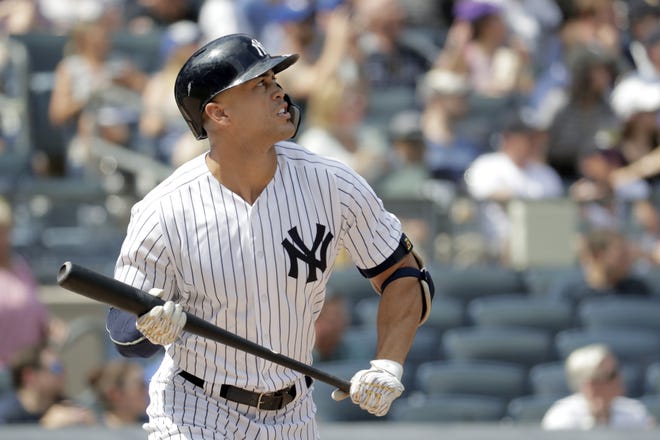 New York Yankees' Giancarlo Stanton watches his solo home run off Toronto Blue Jays starting pitcher Sean Reid-Foley during the fourth inning on Saturday in New York. (AP Photo/Julio Cortez)