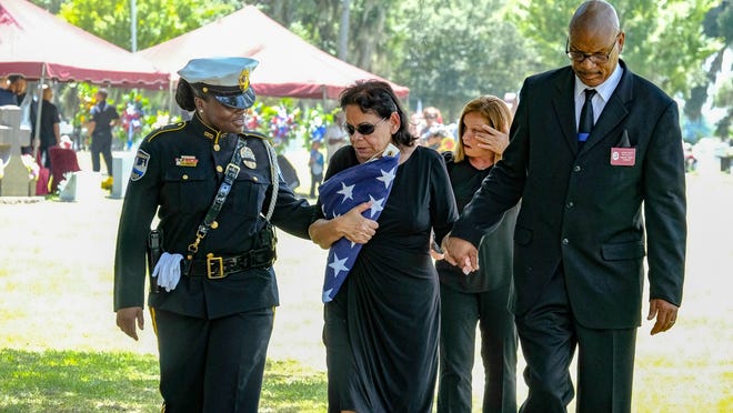 Zoraida Molina is led away from the funeral for her son Cpl. Luis Molina on Saturday. She is flanked by Savannah Police Det. Perneacia Banks and Tony Caldwell. (Robert Cooper/for the Savannah Morning News)