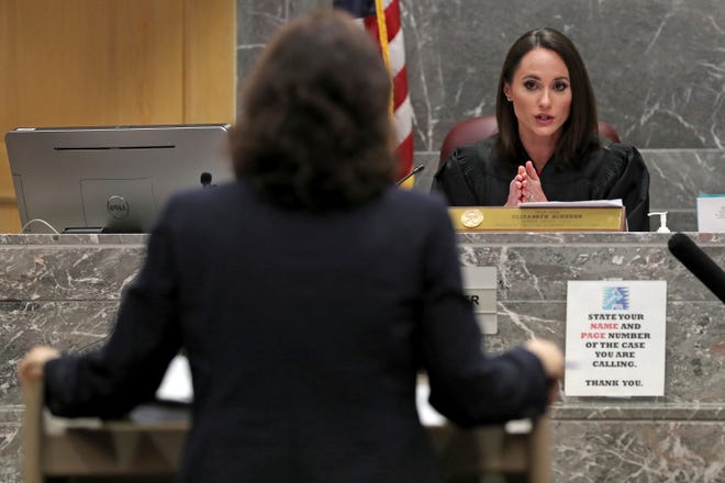 Broward Circuit Judge Elizabeth Scherer, right, speaks to South Florida Sun -Sentinel attorney Dana McElroy at the Broward County Courthouse in Fort Lauderdale. [Amy Beth Bennett/South Florida Sun-Sentinel via AP]