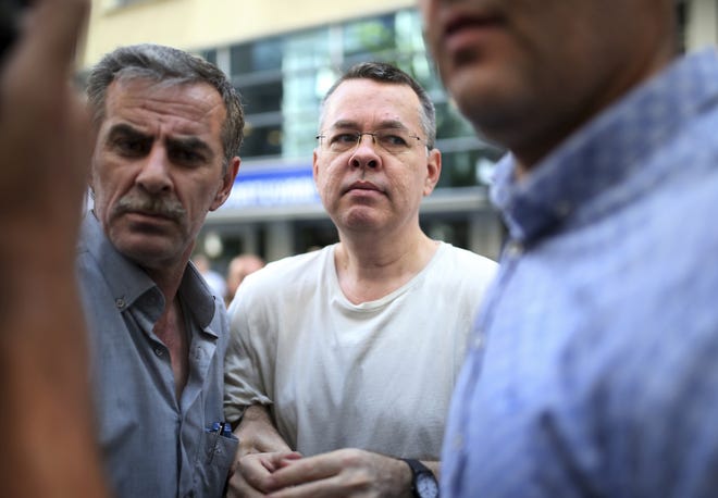 In this July 25 photo, Andrew Craig Brunson, an evangelical pastor from Black Mountain, North Carolina, arrives at his house in Izmir, Turkey.  Brunson, who had been jailed in Turkey for more than one and a half years on terror and espionage charges was released and will be put under house arrest as his trial continues. The White House is announcing that the Treasury Department is imposing sanctions on two Turkish officials over a detained American pastor who is being tried on espionage and terror-related charges. [ EMRE TAZEGUL / AP ]