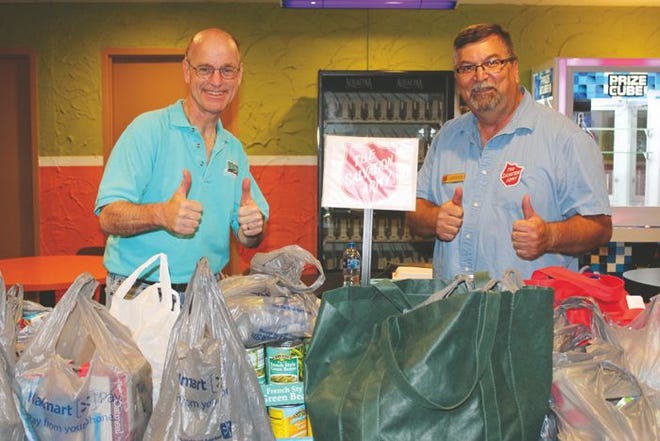 The Cheboygan Salvation Army and Exit Realty Premier held a very successful fundraiser and donation drive at Spare Time Lanes Friday evening, bringing in a large amount of food to help stock the Salvation Army's food pantry. Roger Kopernik of Exit Realty Premier and Roman Hank of the Salvation Army were very pleased with the event.