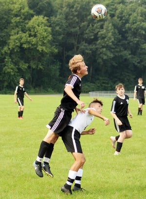 Jonesville´s Devon Bonner-Cook (left) heads the ball during Saturday´s game. (JAMES GENSTERBLUM PHOTO)