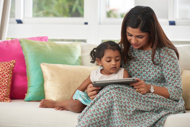 Reading out loud as a family is a great way to encourage curiosity, especially if you adorn every reading session with conversation and questions about the story. [ISTOCK]
