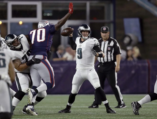 Patriots defensive tackle Adam Butler (70) moves in to sack Eagles quarterback Nick Foles during Thursday's preseason game. [CHARLES KRUPA/THE ASSOCIATED PRESS]