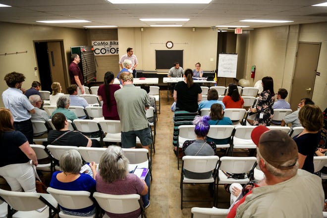 Attendees stand to volunteer to fill precinct vacancies during a Boone County Democratic Central Committee meeting at the Armory Sports Center on Tuesday, August 21, 2018. [Hunter Dyke/Tribune]