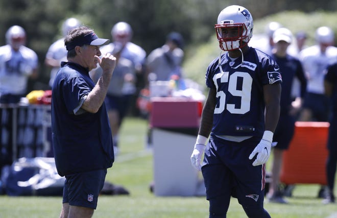 Patriots head coach Bill Belichick talks with New England Patriots linebacker Marquis Flowers (right) during a training camp practice on May 31. Flowers says he's starting fresh this season despite finishing last year on a high note. [AP Photo/Charles Krupa]
