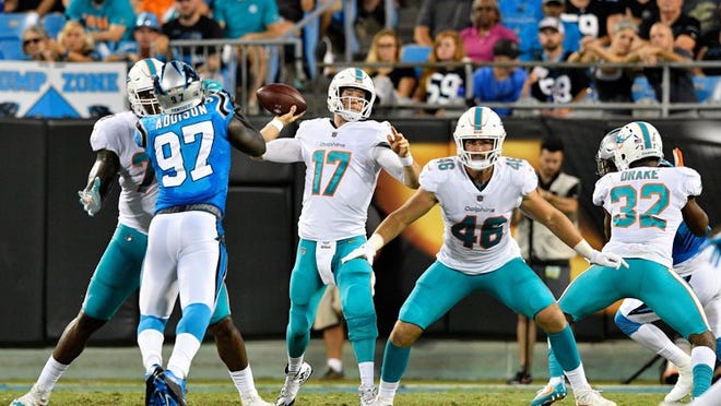 Ryan Tannehill of the Miami Dolphins throws a pass against the Carolina Panthers.