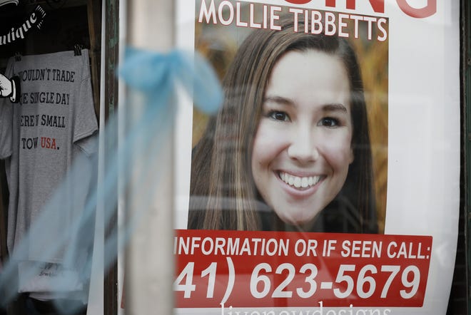 A poster for missing University of Iowa student Mollie Tibbetts hangs in the window of a local business Tuesday in Brooklyn, Iowa. Tibbetts was reported missing from her hometown in the eastern Iowa city of Brooklyn in July 2018. [AP Photo/Charlie Neibergall]