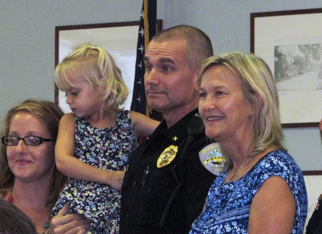 Interim police chief Scott Chandler accepts a recognition last week from Mayor Lisa Sulka, right, alongside his wife and daughter. [Dan Hunt/Bluffton Today]