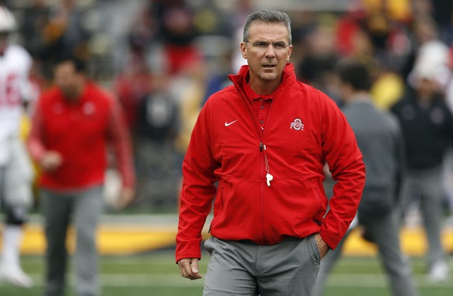 FILE - In this Nov. 4, 2017, file photo, Ohio State coach Urban Meyer walks on the field before the team's NCAA college football game against Iowa in Iowa City, Iowa. Ohio State trustees are set to discuss the future of football coach Urban Meyer. The 20-member board plans to meet in private on Wednesday morning, Aug. 22, 2018, in Columbus to decide whether Meyer should be punished for his handling of domestic-abuse allegations against a former assistant coach. [AP Photo/Charlie Neibergall, File]