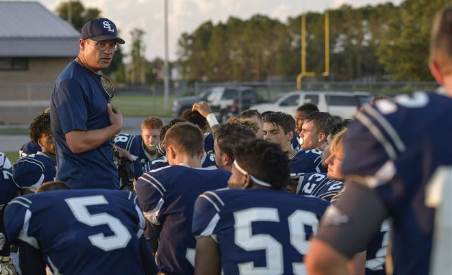 South Lake coach Mark Wollum talks with his team during a spring football game in Groveland. [DAILY COMMERCIAL FILE]