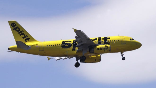 A Spirit Airlines passenger jet plane, an Airbus 319 model, approaches Logan Airport in Boston, Thursday, May 24, 2018. (AP Photo/Charles Krupa, file)