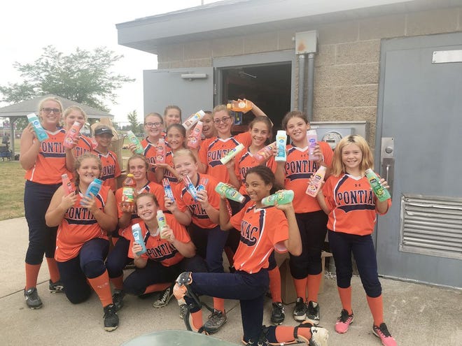 The Pontiac Junior High softball team collects 357 items for the Livingston County Community Food Pantry during their game in Pontiac against Bloomington Junior High on Aug. 16.