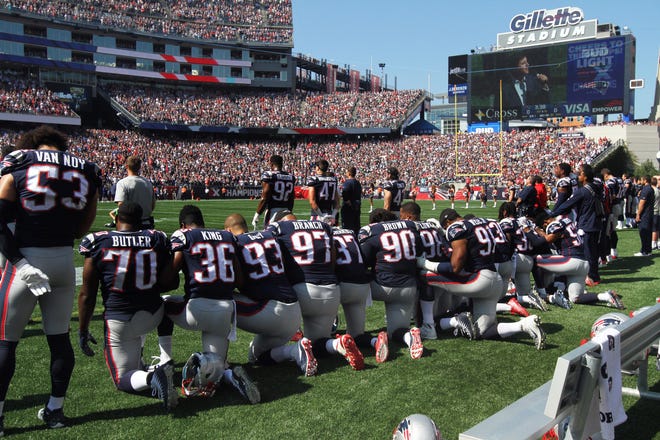 Many players from the Patriots took a knee during the singing of the national anthem in September 2017. [The Providence Journal/Bob Breidenbach]