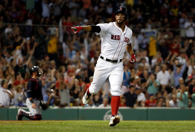 Xander Bogaerts points to the Boston dugout after hitting a home run against the Indians in the fourth inning on Wednesday night.