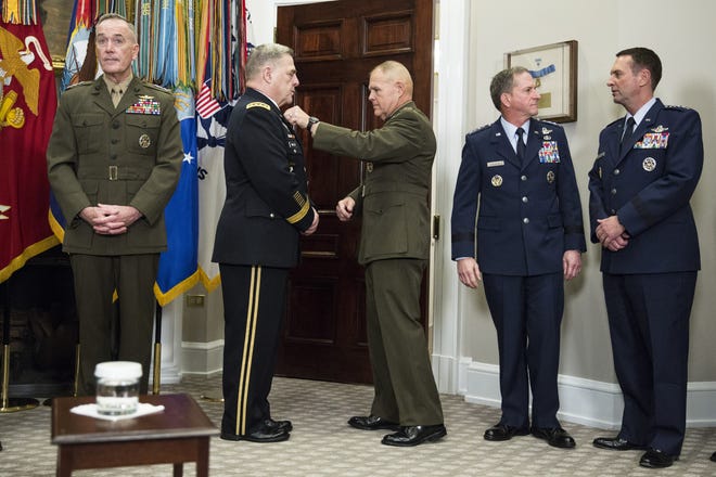 Marine, Army and Air Force uniforms seen on military leaders in the Roosevelt Room of the White House in Washington, D.C., on Dec. 12, 2017. At center, Gen. Robert Neller, commandant of the U.S. Marine Corps, adjusts the uniform of Gen. Mark Milley, chief of staff with the U.S. Army. MUST CREDIT: Joshua Roberts/Bloomberg