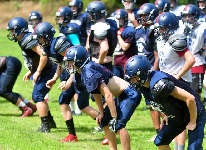 Pembroke High School football players ready themselves to run up a hill during a practice Wed. August 22 at Pembroke High School. [Wicked Local Photo/William Wassersug]
