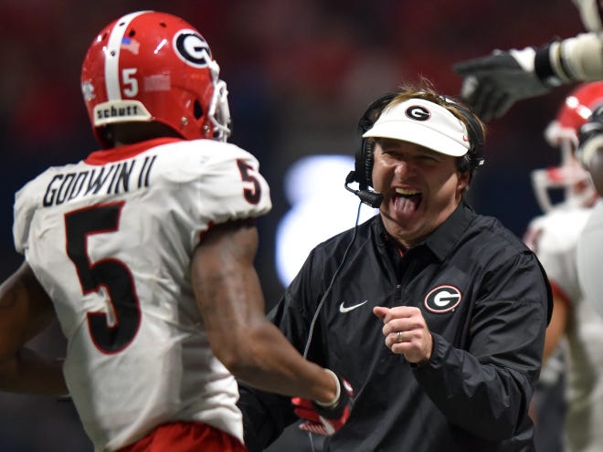 Georgia head coach Kirby Smart reacts with Georgia wide receiver Terry Godwin during last year's SEC Championship game. Under Smart, Georgia has increased its athletic budget to $143 million in order to compete with other top programs. (AJ Reynolds for the Athens Banner-Herald)