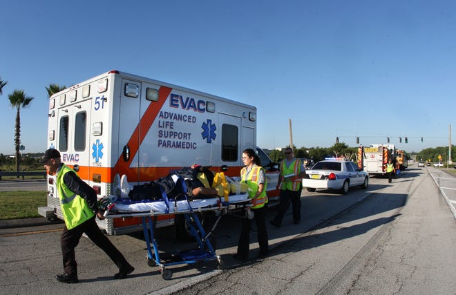 EVAC personnel prepare to load a crash victim into an ambulance on 11th Street in Daytona Beach in 2012. Port Orange city leaders are preparing their budget and leaning toward purchasing an ambulance and hiring four additional staff members to operate it. [News-Journal file/Jim Tiller]