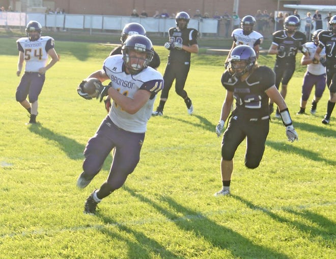 Bronson's Justin Blankenship pulls in a pass ahead of Athens' Luke Fuller Thursday in the season opener for both teams.