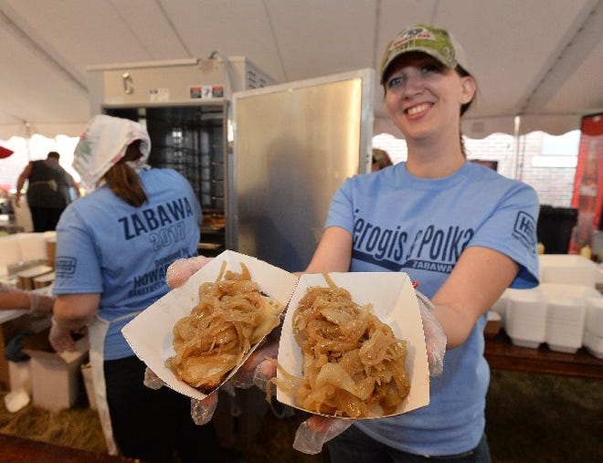 Jenny Donor shows off cheese pierogis during 2017's Zabawa Polish Heritage Festival. The festival (and pierogis) return this weekend at Holy Trinity Catholic Church. [FILE PHOTO/ERIE TIMES-NEWS]