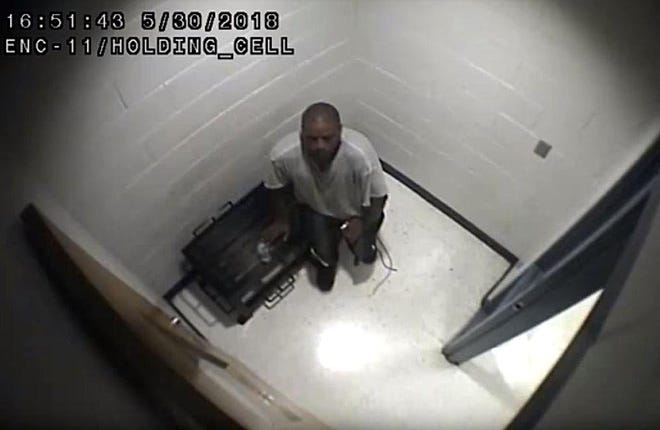 This is a screenshot of surveillance video footage taken from inside a holding cell at Erie County's work-release center. Footage provided by Erie County shows the minutes before inmate Felix L. Manus received medical care on May 30. The lawyer for the Manus family charges that corrections officers delayed calling 911 after Manus suffered an asthma attack during a work-release detail near Edinboro. [CONTRIBUTED PHOTO]