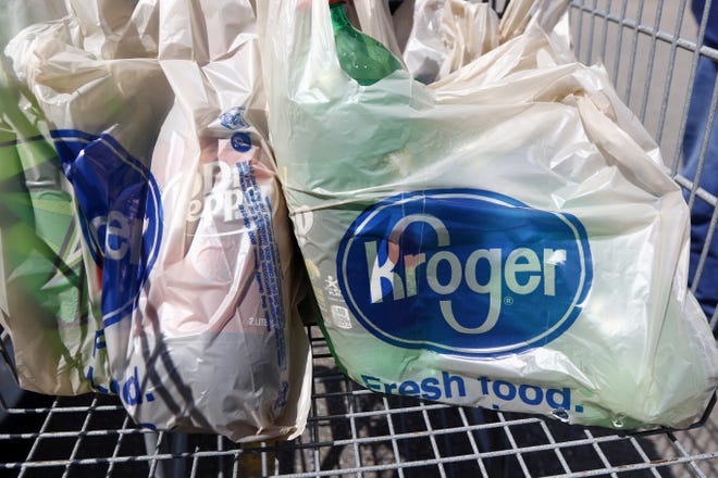 FILE - This June 15, 2017, file photo shows bagged purchases from the Kroger grocery store in Flowood, Miss. The nationþÄôs largest grocery chain will phase out the use of plastic bags in its stores by 2025. (AP Photo/Rogelio V. Solis, File)