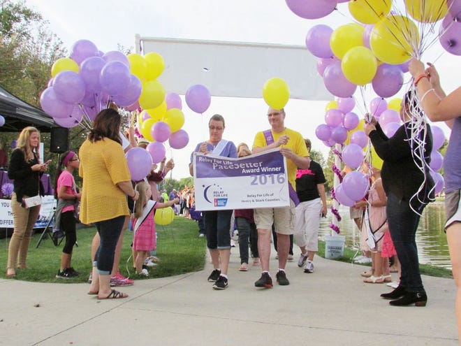 Diane Savage (on left, holding banner), the 2017 Relay for Life honorary survivor, starts the walk at last year’s event, which raised $60,000.