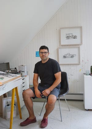 Kevin Cyr in his studio. The two drawings behind him are part of his show opening at the Alden Gallery on Friday. [Photo Jennifer Lopardo]