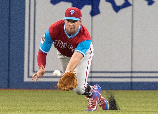 The Phillies' Rhys Hoskins makes a catch off the bat of the Blue Jays' Kevin Pillar during Friday's game. [Fred Thornhill/The Canadian Press via AP]