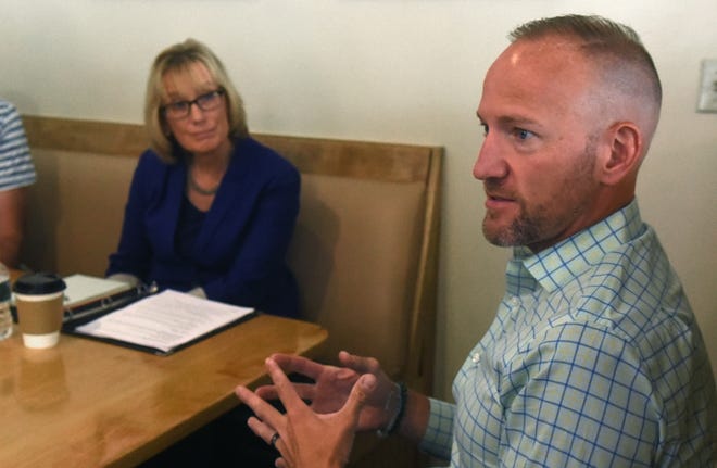 Matthew McDonald of Stratham shares his son's medical condition in a gathering led by U.S. Sen. Maggie Hassan in Portsmouth with a few Granite Staters who discussed what protections for pre-existing conditions mean to them personally. [Deb Cram/Seacoastonline]