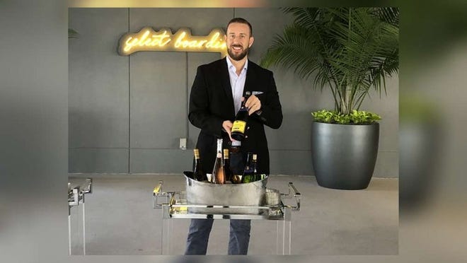Brightline President and COO Patrick Goddard displays a selection of wine and champagne available to Brightline passengers who opt for the private rail operator’s new Select service, which debuted Friday. (Jodie Wagner/Palm Beach Post)