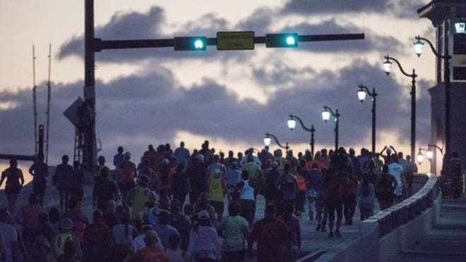Runners cross the Flagler Memorial Bridge on their way to Palm Beach during the Palm Beaches Marathon in West Palm Beach on Sunday, Dec. 3, 2017. (Andres Leiva / The Palm Beach Post)