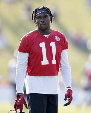 Atlanta Falcons wide receiver Julio Jones walks on the field during training camp July 27 in Flowery Branch. After skipping minicamp and offseason workouts, Julio Jones reported to training camp saying he has never felt better physically. The Falcons want to keep it that way, planning to hold the wide receiver out of all preseason games, including Saturday's game at Jacksonville. [DAVID GOLDMAN/AP FILE PHOTO]